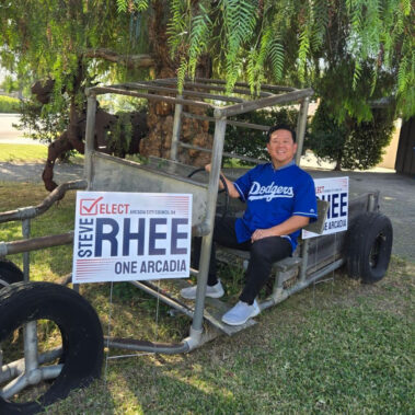 Steve Rhee sitting a metal car.