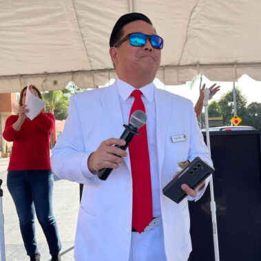 Steve Rhee speaking on stage at an event.