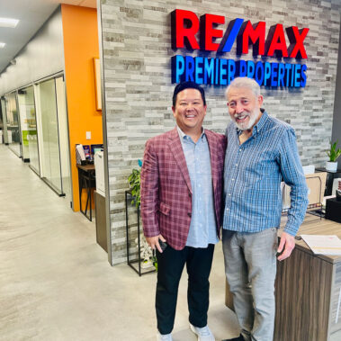 Steve Rhee with Martin Gandell in front of REMAX Sign.