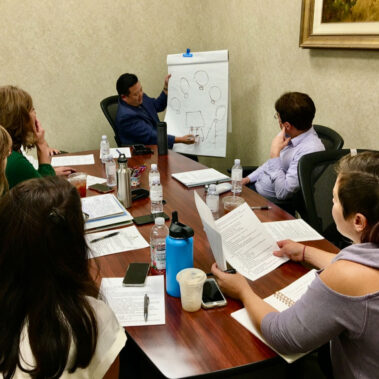 Steve Rhee giving a presentation at a meeting.