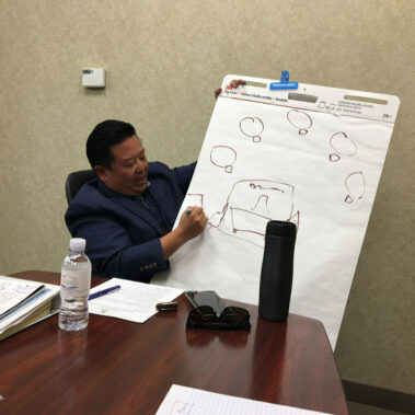 Close up of Steve Rhee giving a presentation at a meeting.