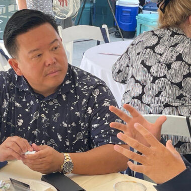 Talking to a resident at an event.