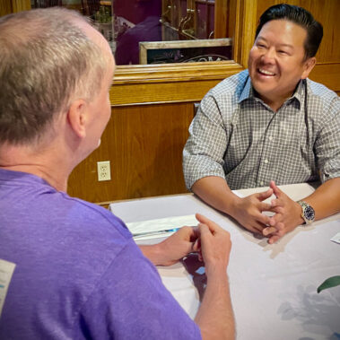 Steve Rhee talking a resident man at a restaurant.
