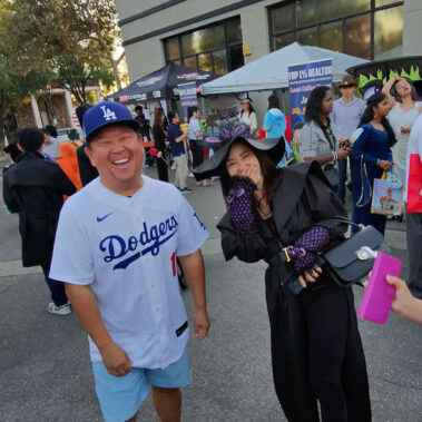 Steve Rhee laughing with a spectator at the Downtown Arcadia Halloween Haunting.