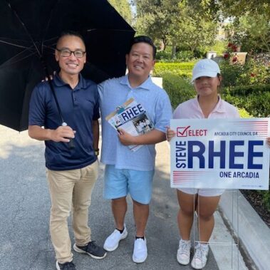 Steve Rhee posing for a picture with man and his dauhter.