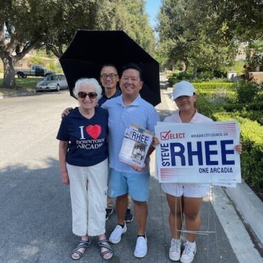 Steve Rhee posing for a picture with a couple and his daughter.