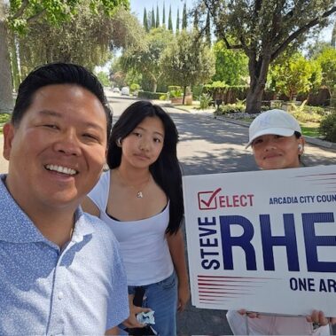 Steve Rhee posing for a picture with his daughters.