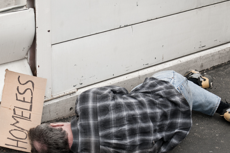 HomlessMan Homeless man sleeping on sidewalk