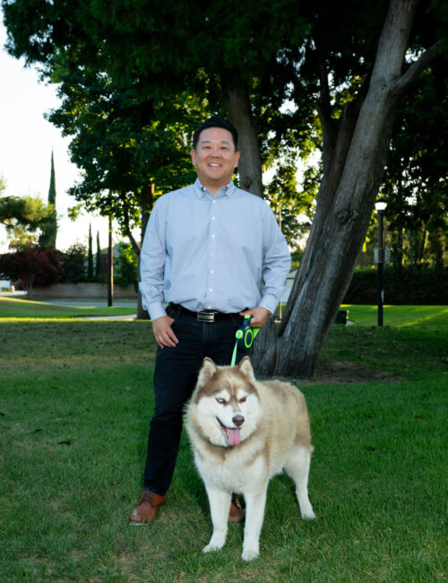 Steve standing for a picture with his dog.